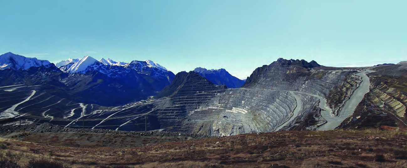Open pit mine with mountains in the background
