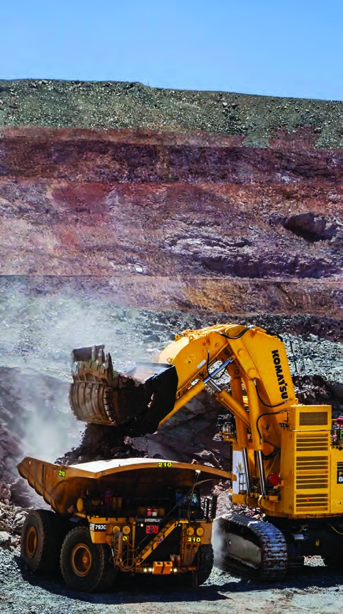 Excavator loading a haul truck in a mine
